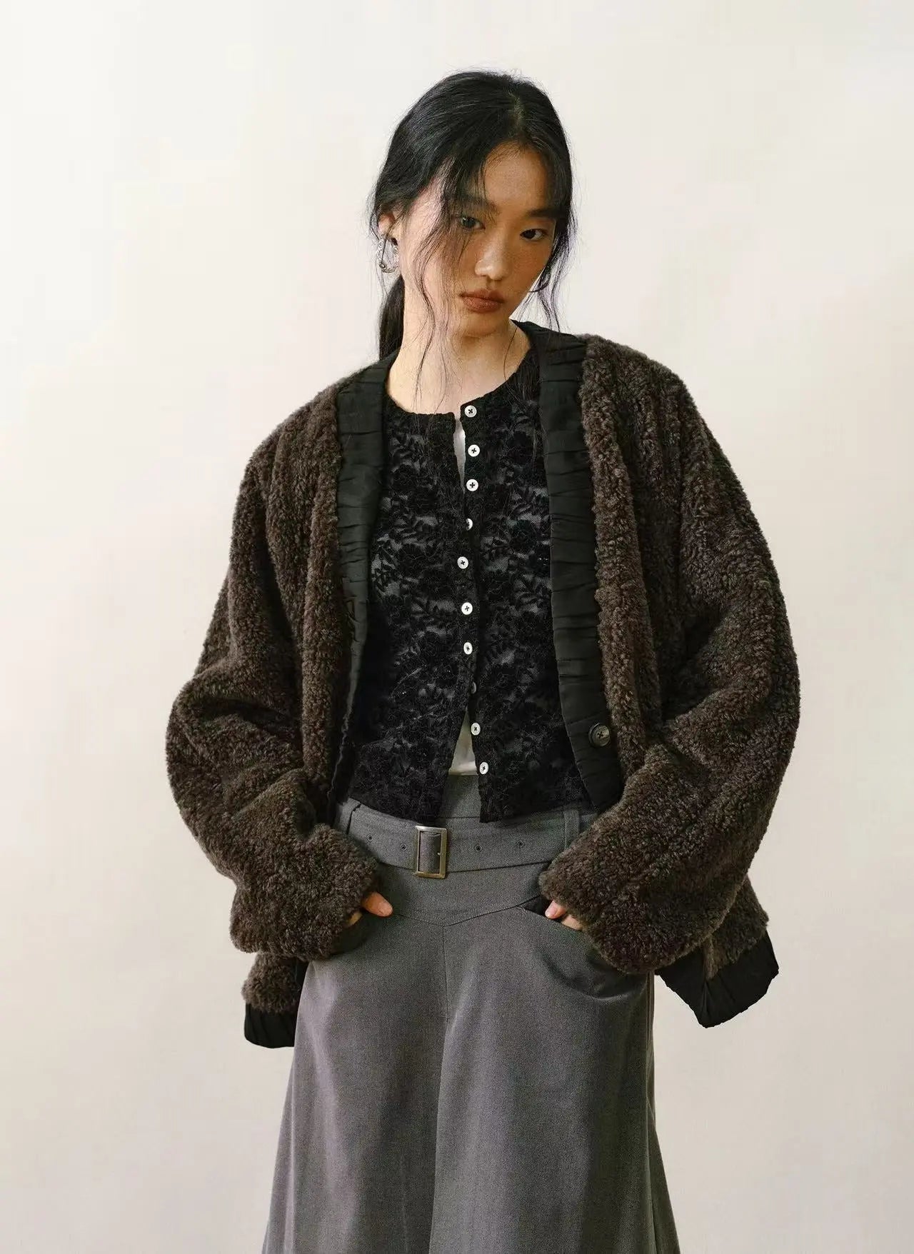 Tan faux shearling coat with cream-colored plush lining and large statement buttons on a white background.