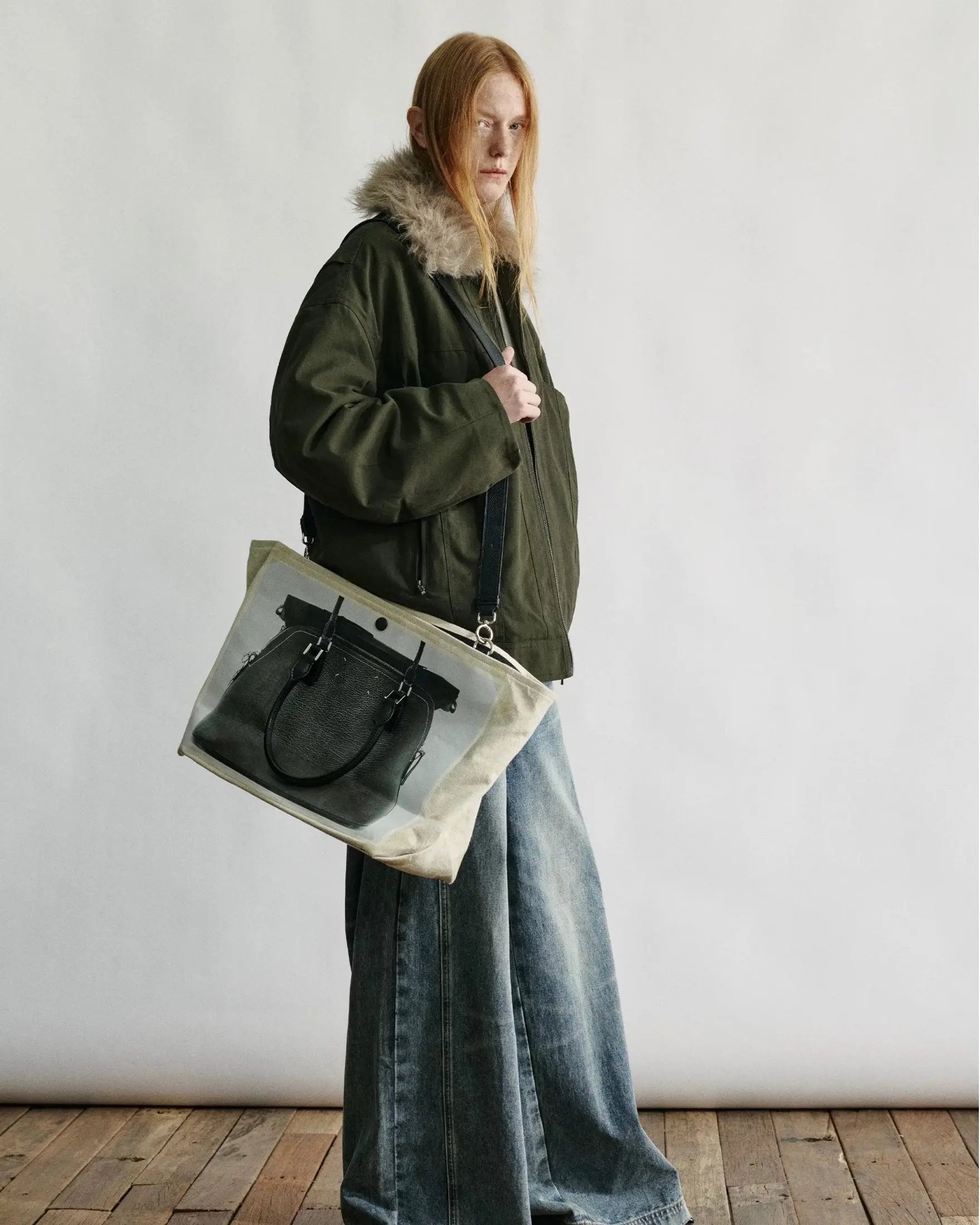 Full-length view of a navy blue down parka with a fur-trimmed hood and multiple utility pockets.