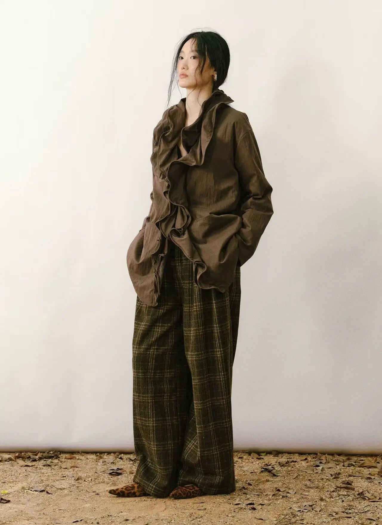 An outdoor hiker wearing a lightweight down jacket while trekking through a scenic mountain trail.