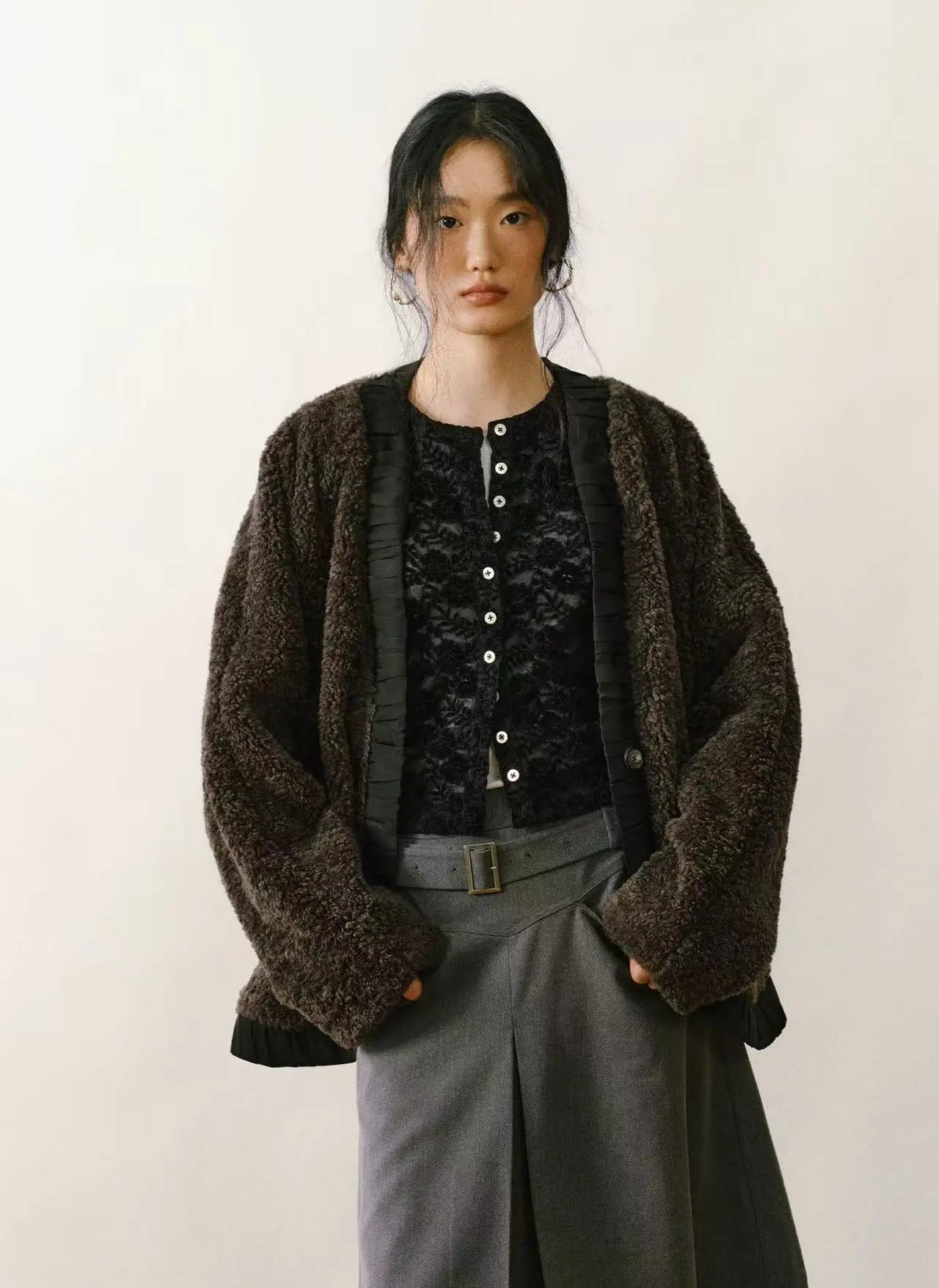 Tan faux shearling coat with cream-colored plush lining and large statement buttons on a white background.
