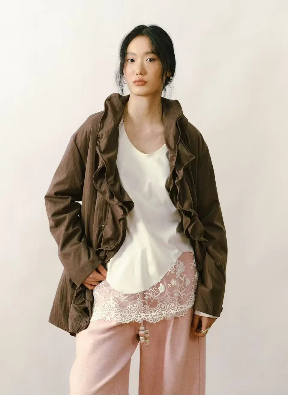 An outdoor hiker wearing a lightweight down jacket while trekking through a scenic mountain trail.