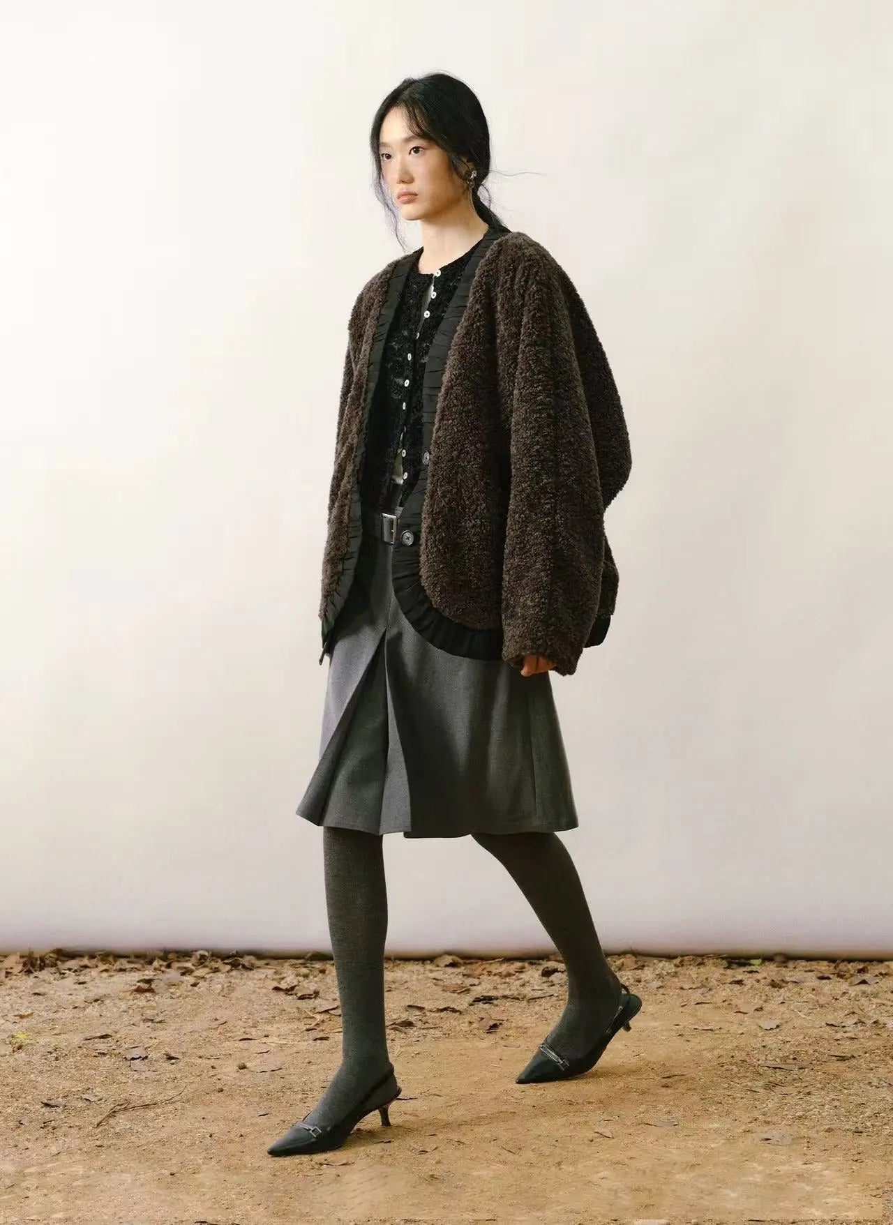 Tan faux shearling coat with cream-colored plush lining and large statement buttons on a white background.